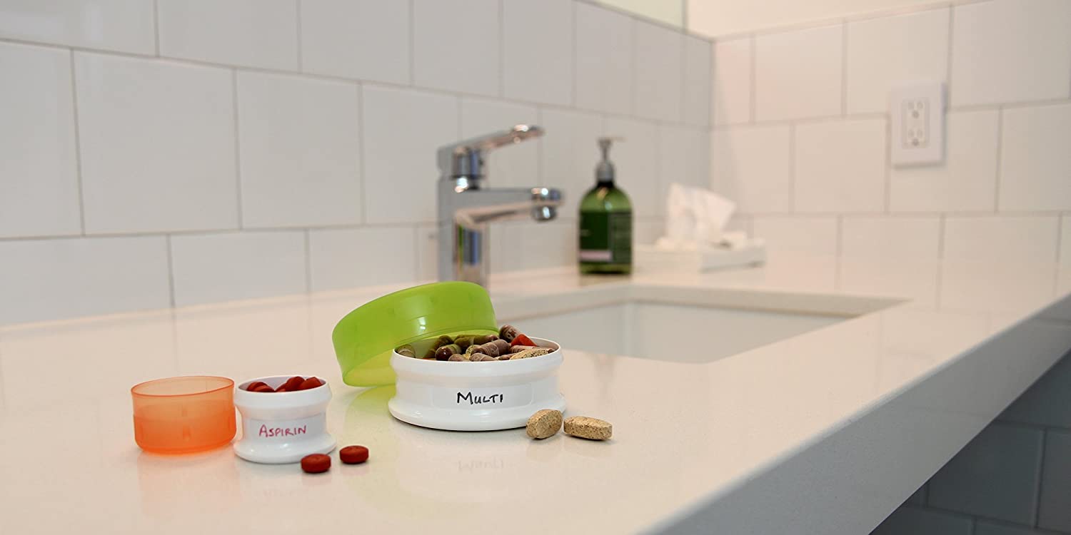 Medium and large Go Tubbs on hotel bathroom counter with medications in