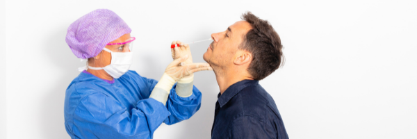 Man getting COVID test from nurse