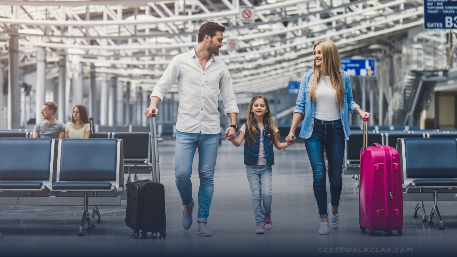 Happy family walking through airport together 