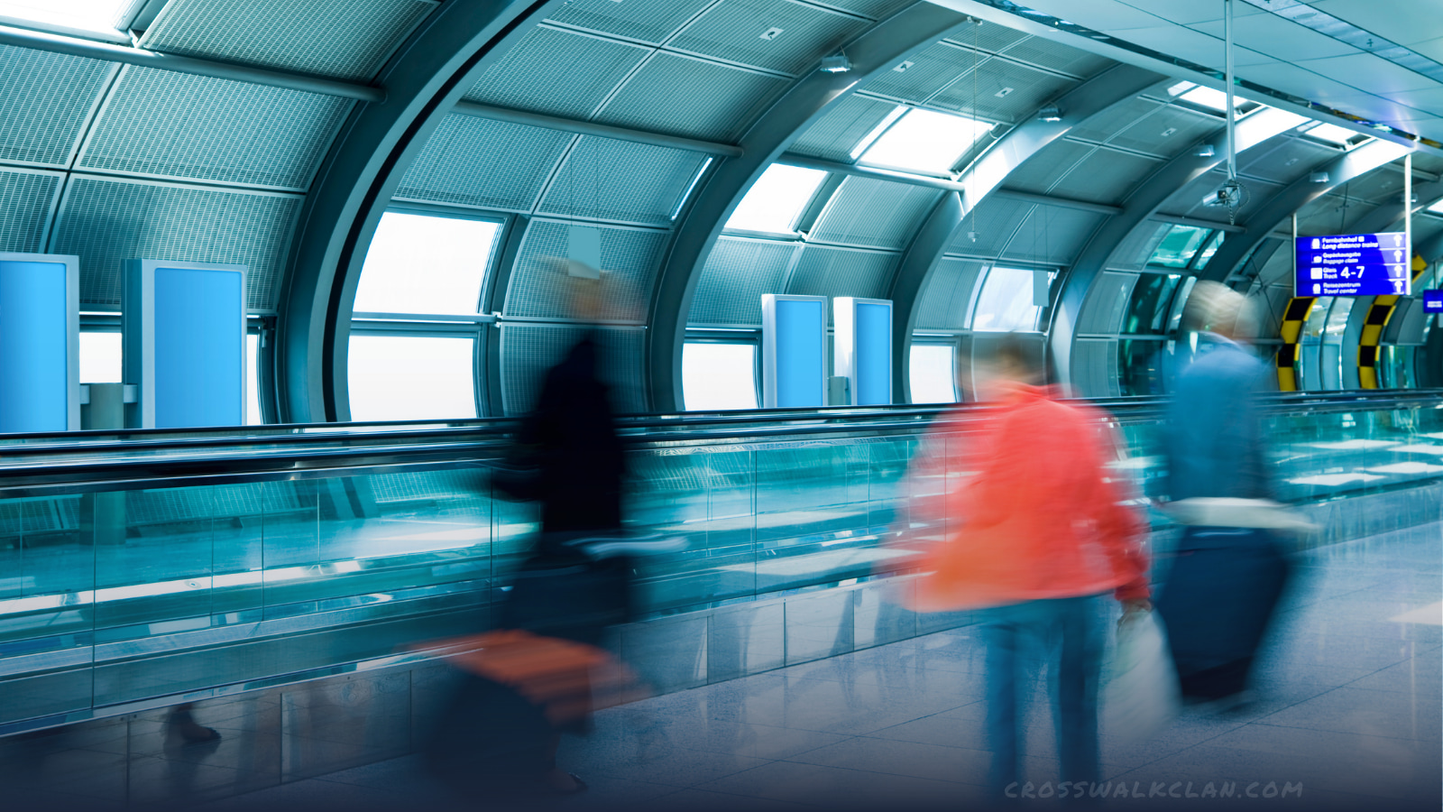Passengers walking through airport terminal building with motion blur