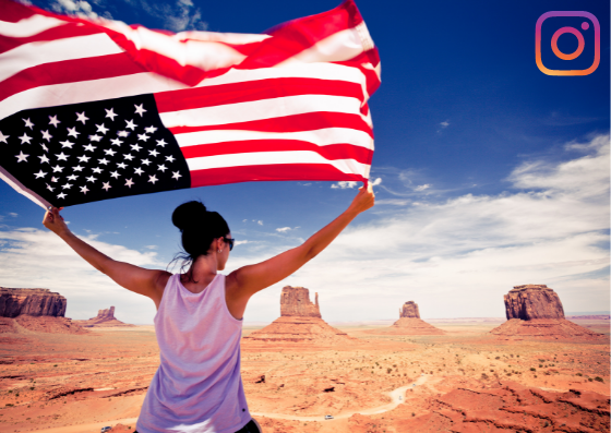 Woman waving American flag in dessert