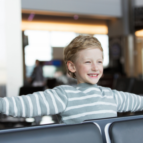 excited young boy at airport